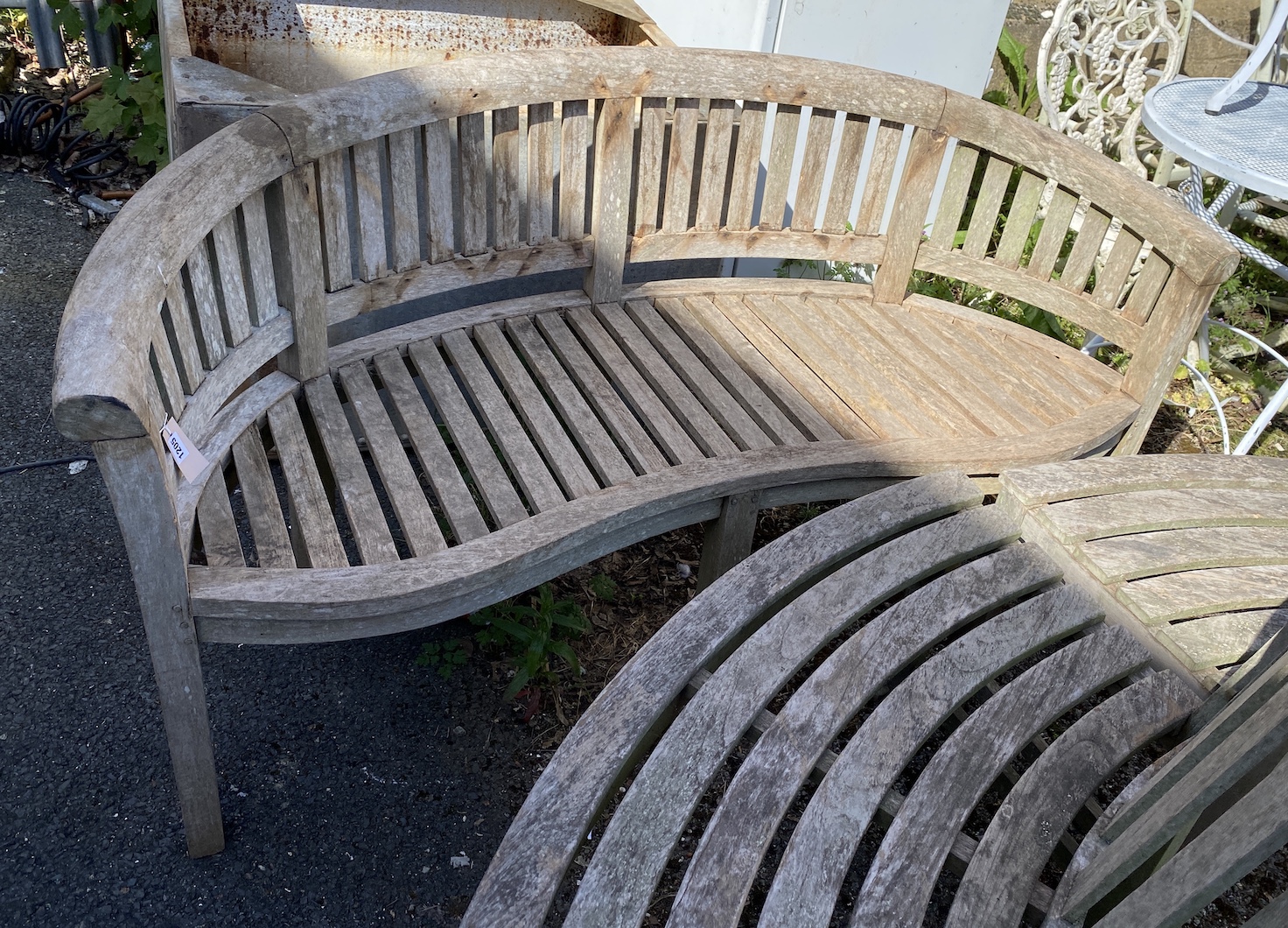 A weathered teak garden banana bench, width 160cm, height 82cm